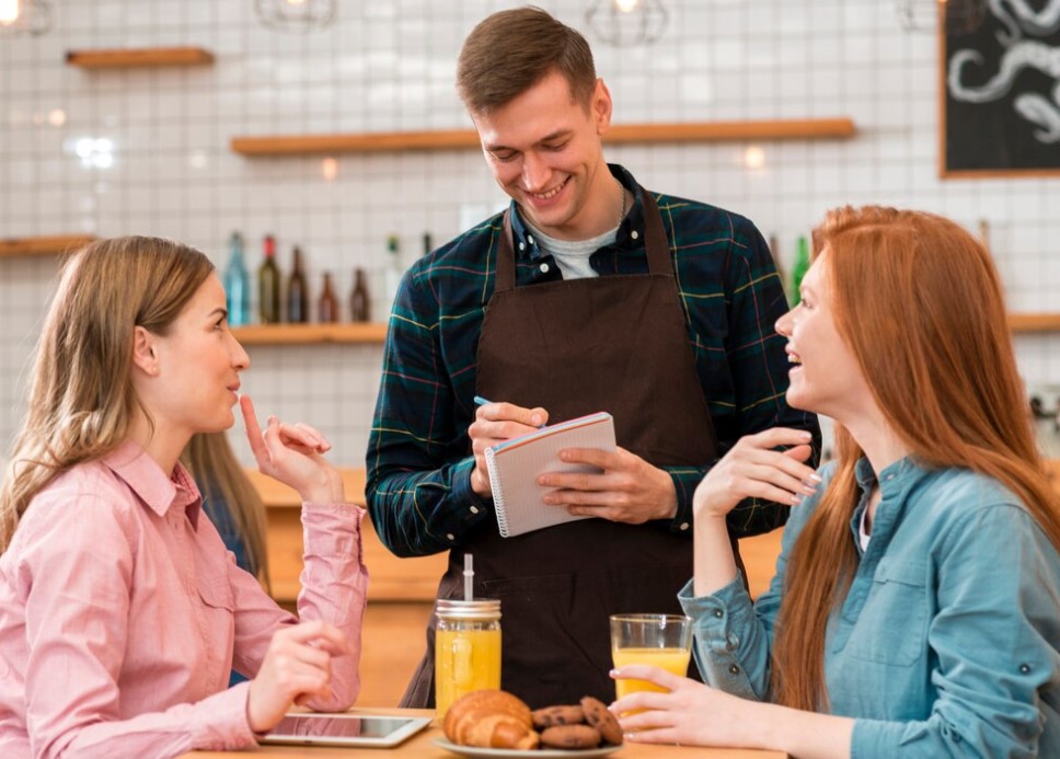 The waiter gives advice on food pairings for a better customer experience